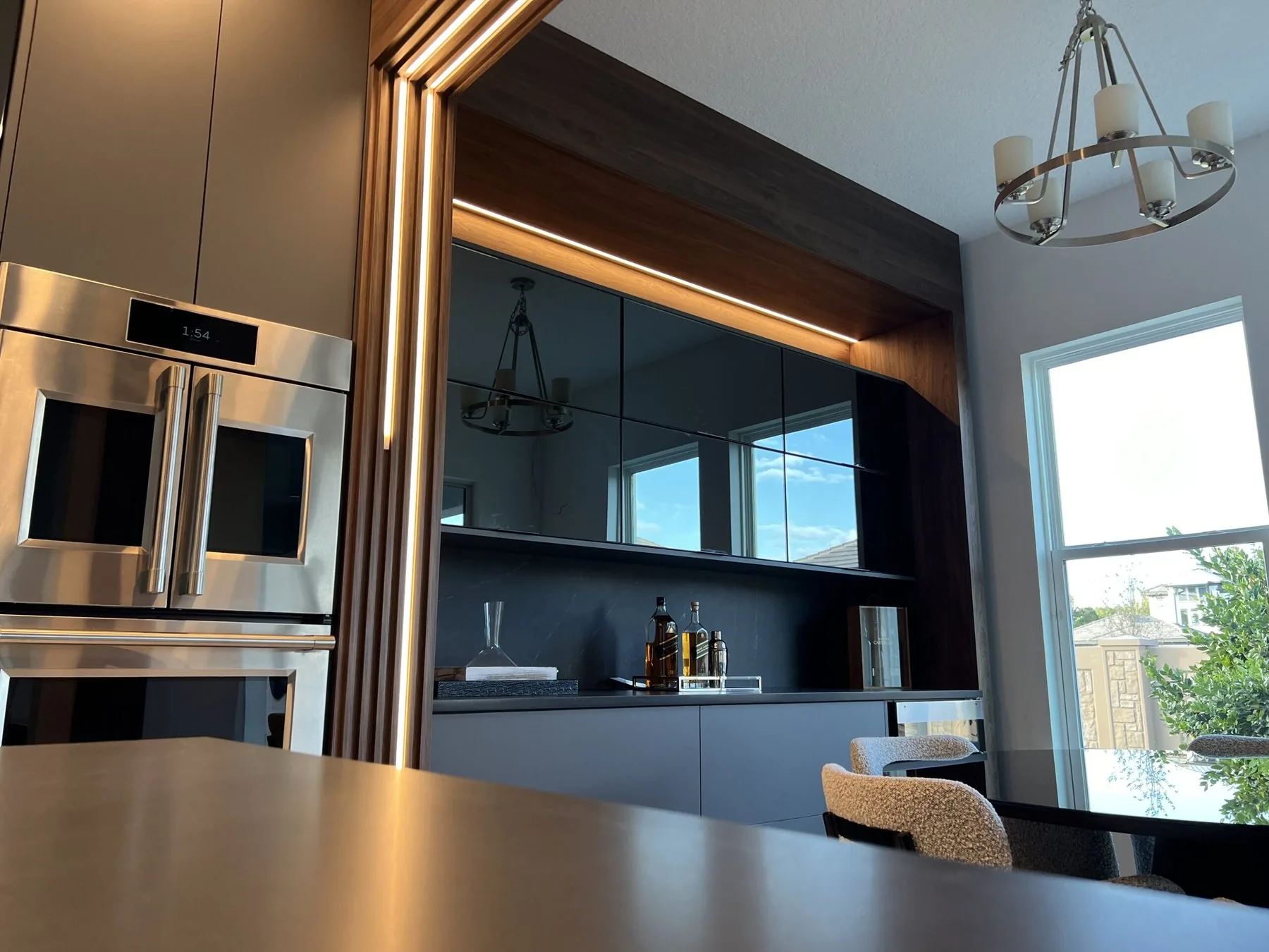 European style antracita frameless kitchen with smoked glass doors and LED lighting